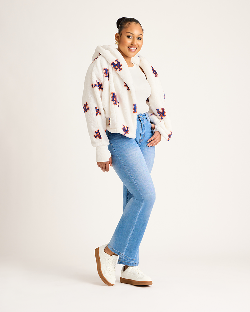 Woman wearing a mets hoodie and blue jeans on a white background|Model: 5'9" in size XS/S
