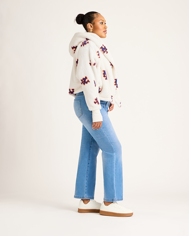 Woman wearing a mets hoodie and blue jeans on a white background|Model: 5'9" in size XS/S
