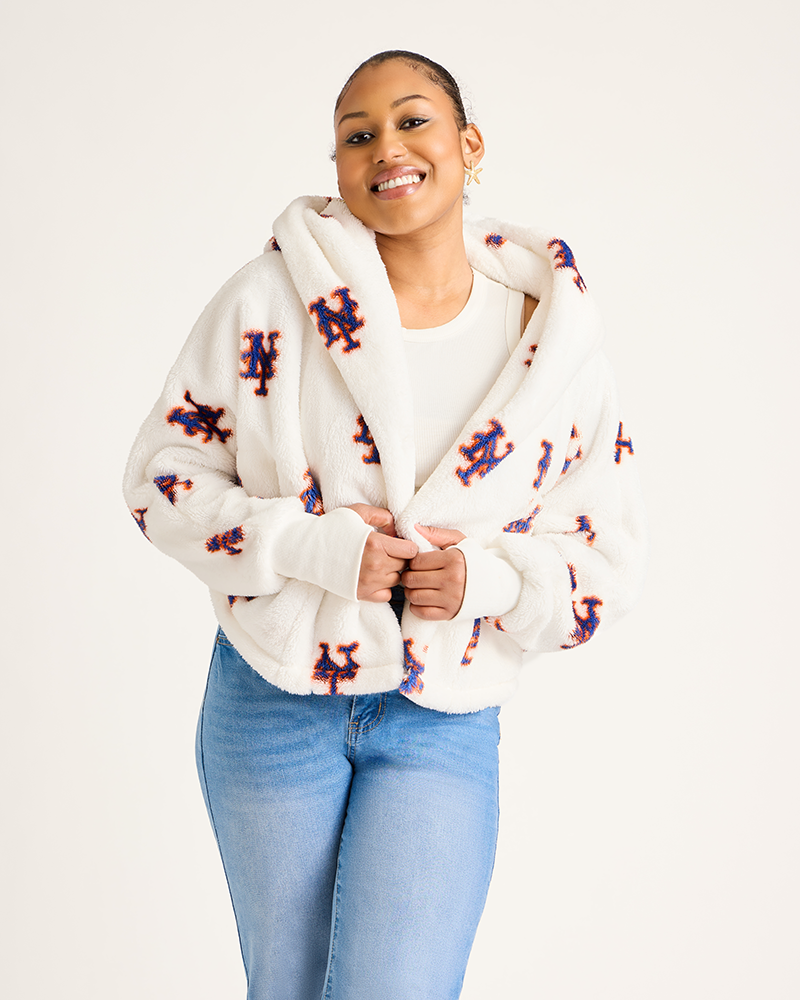 Woman wearing a white hoodie with colorful patterns on a plain background|Model: 5'9" in size XS/S