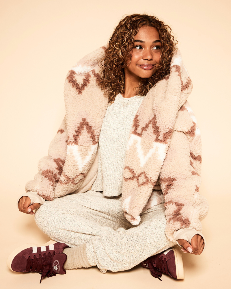 girl wearing faire isle lounger over sweatsuit sitting against beige background