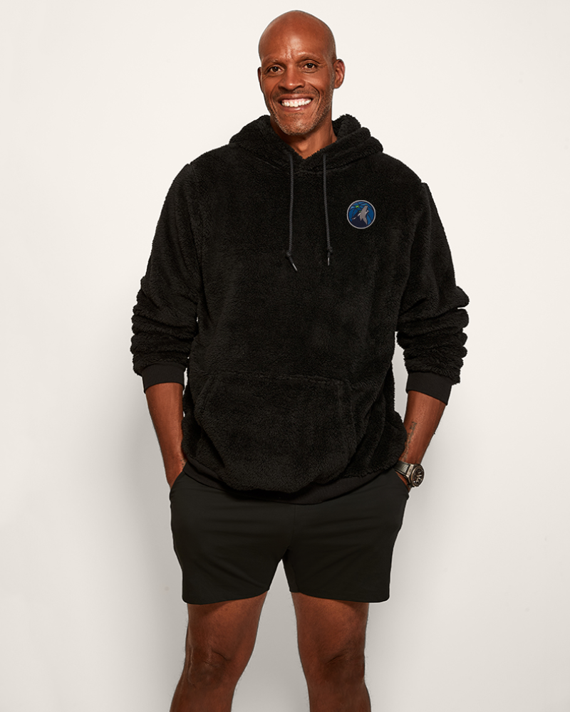 Man wearing a black hoodie with a thunder logo on a white background
