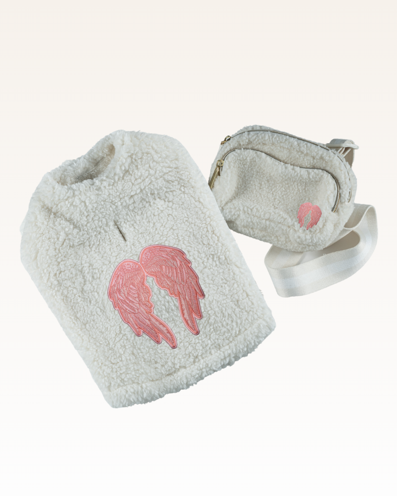 Light gray fuzzy pouch with pink angel wings design and matching pet jacket on a white background