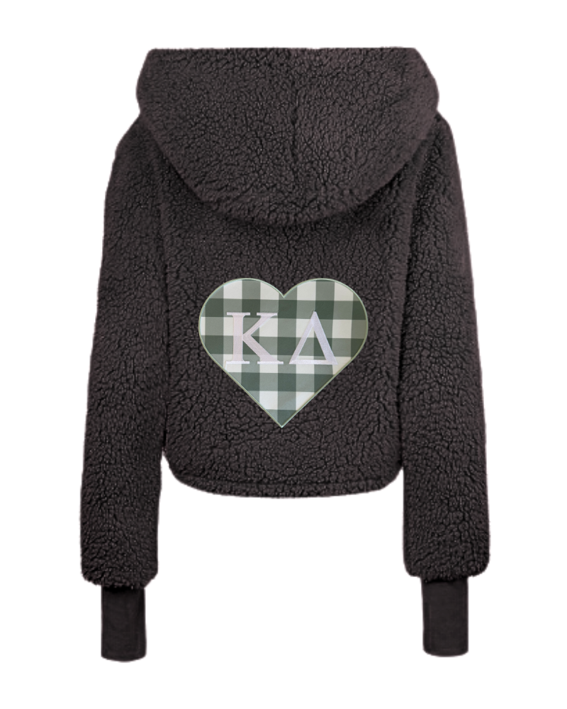 A black sherpa fleece cropped hoodie shown from the back, featuring a green and white gingham heart patch with the Greek letters 'Kappa Delta' in white.