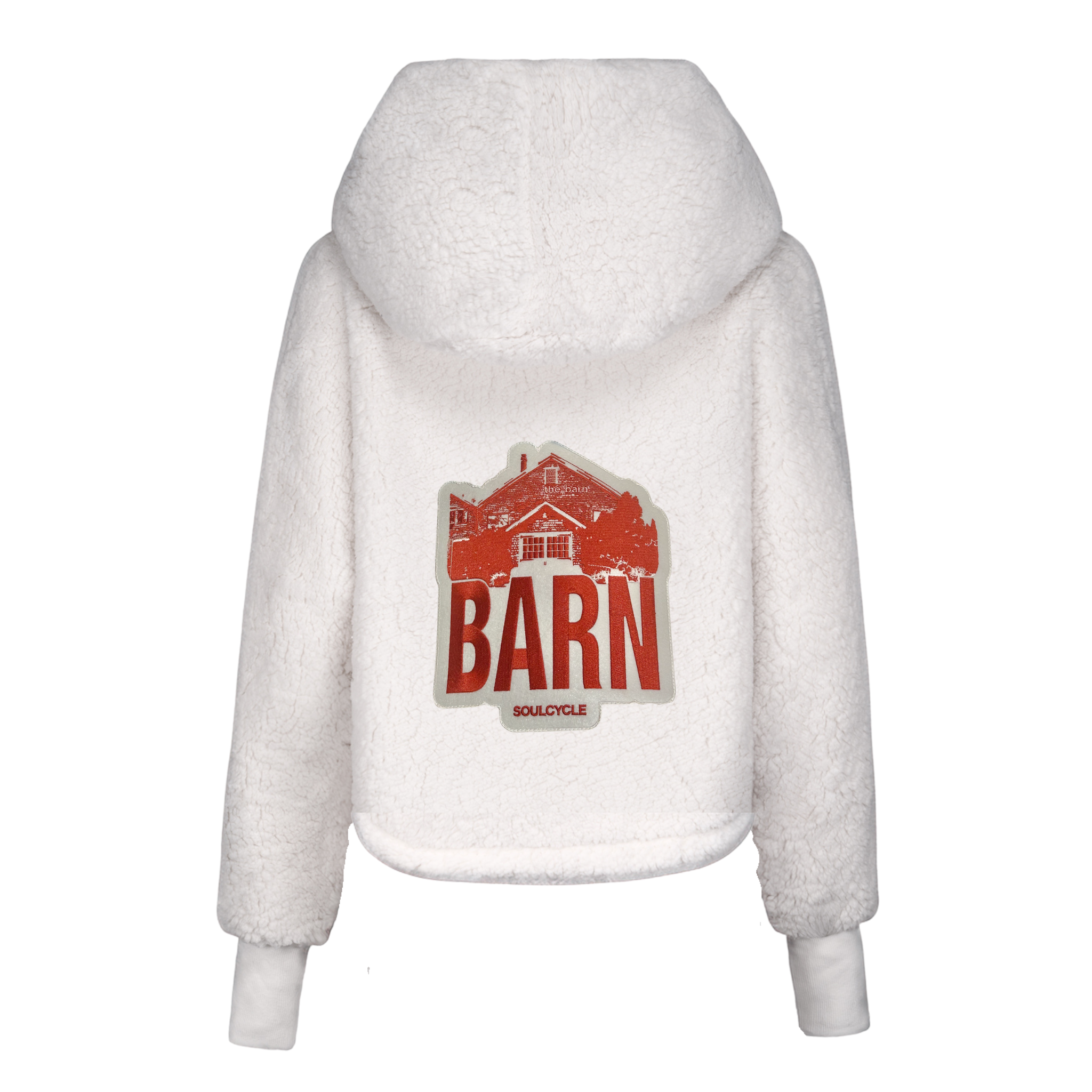 White sherpa hoodie featuring a large red graphic patch on the back with an illustration of a barn and the bold text “BARN” above the smaller word “SOULCYCLE.” The lounger has a cozy hood and cuffed sleeves.