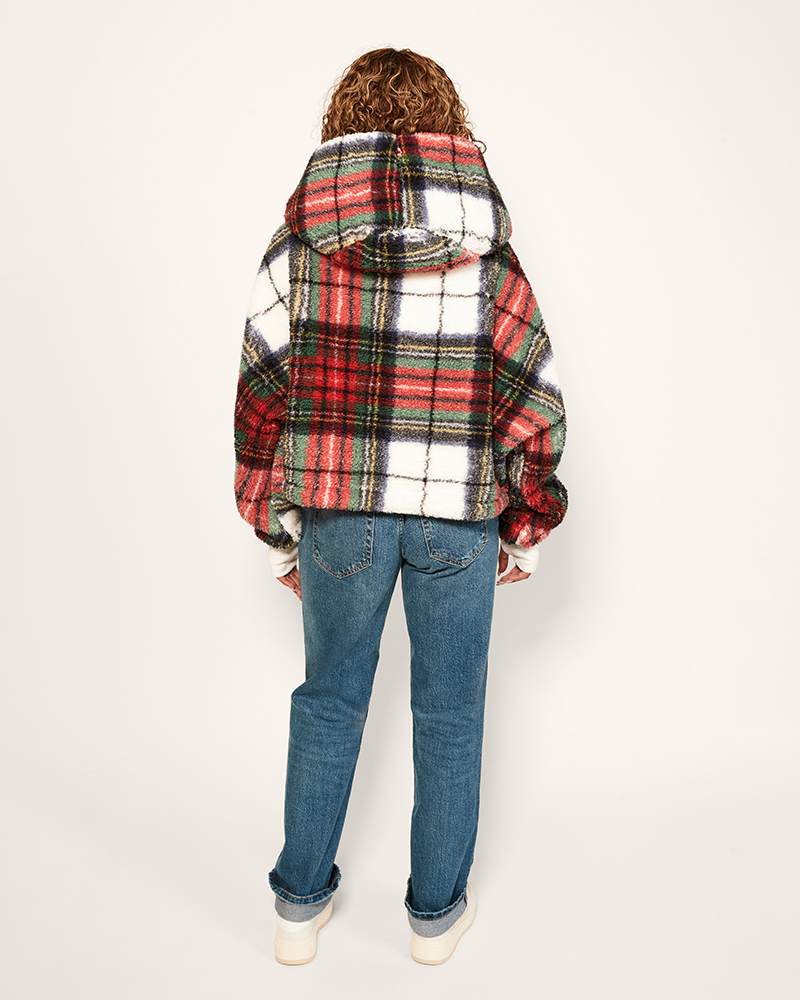 Person wearing a plaid jacket and jeans on a white background